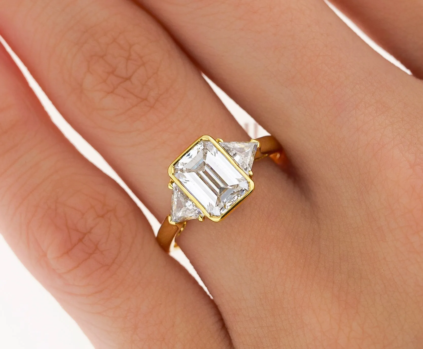Boucheron Signed Ring With Bezel Set GIA Certified 2.09 Carat Emerald Cut E/SI1 Diamond and Trillion Side Stones