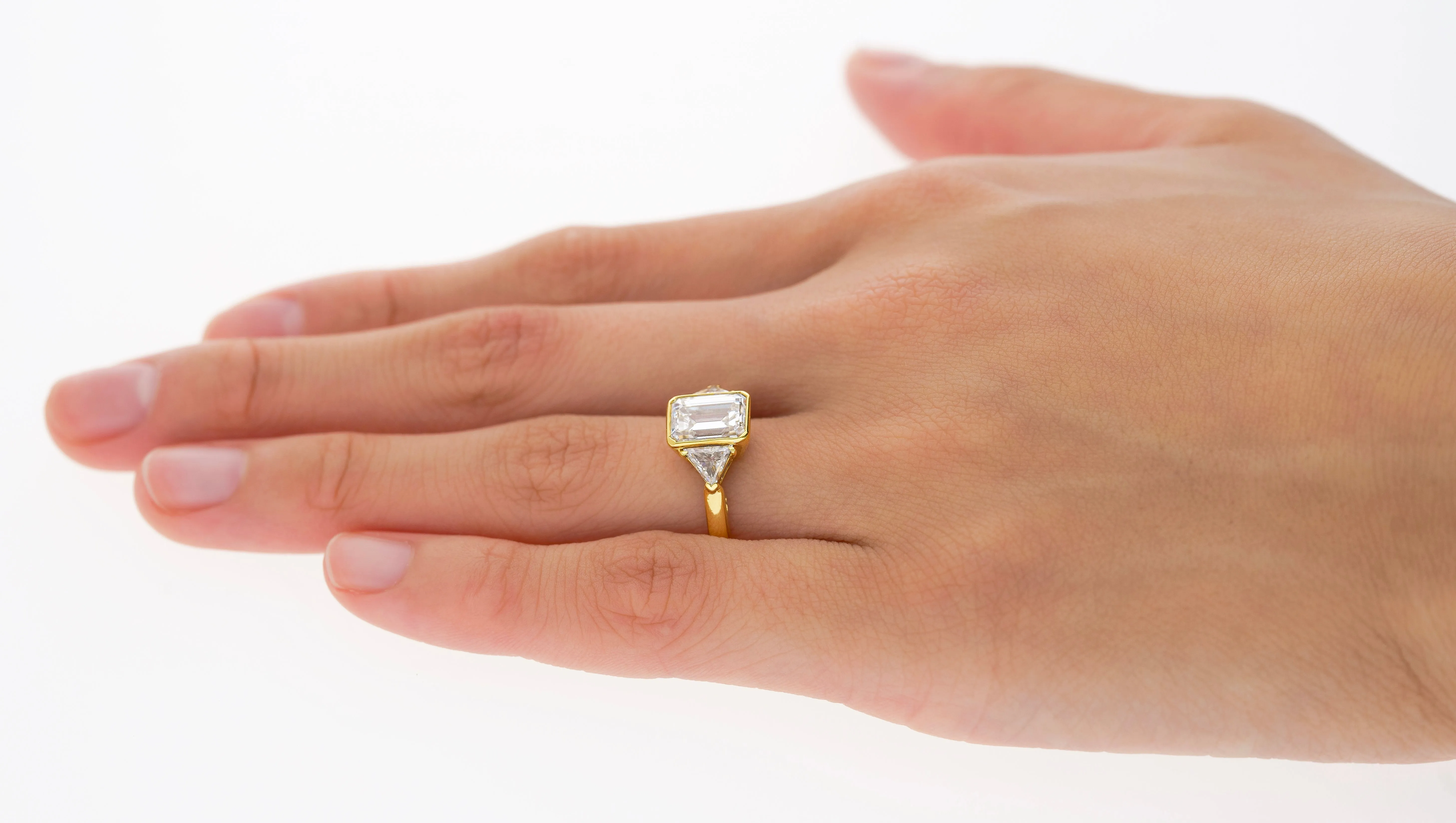 Boucheron Signed Ring With Bezel Set GIA Certified 2.09 Carat Emerald Cut E/SI1 Diamond and Trillion Side Stones